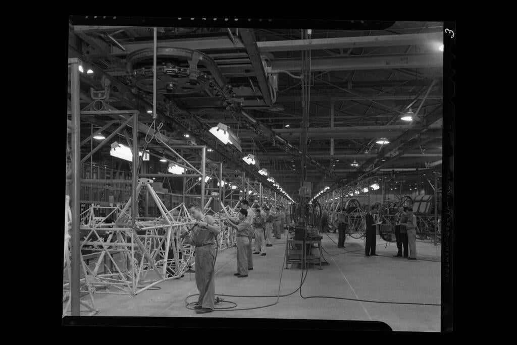Assembly line at night, Downey, Calif., 1941